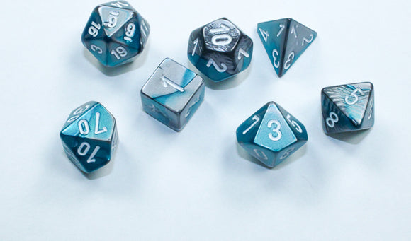 A set of eight Mini Gemini RPG dice featuring a vibrant steel-teal and white color scheme, showcasing various shapes like d4, d6, d8, d10, d12, and d20. The dice have clear, easy-to-read numbers and a glossy finish, perfect for tabletop role-playing games.