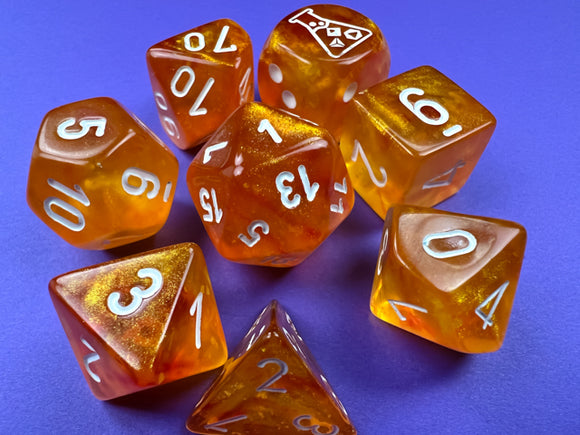 A vibrant 7-piece dice set featuring orange and white luminary design, each die displaying clear numbers and a unique aesthetic. Perfect for tabletop gaming.