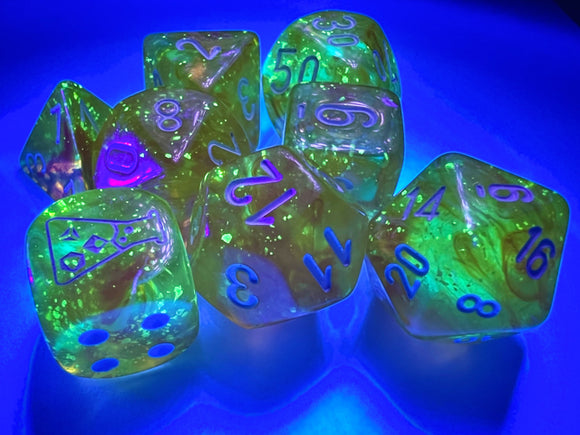 A vibrant set of Borealis Canary and White Luminary polyhedral dice, glimmering under a blue light. The dice feature various shapes including d20, d12, d10, d8, d6, and d4, with bright yellow and white colors and vivid blue numbers, showcasing a luminous and glittery appearance, perfect for tabletop games.
