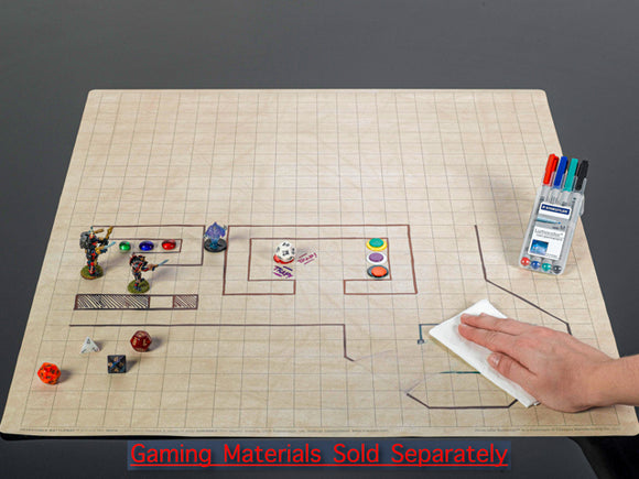 Double-Sided Battlemat by Chessex laid out on a flat surface. The mat features a grid pattern with illustrations including game tokens, dice, and a person wiping the surface. Additional gaming materials like markers are visible in the background, emphasizing its use for tabletop gaming. Note: Gaming materials sold separately.