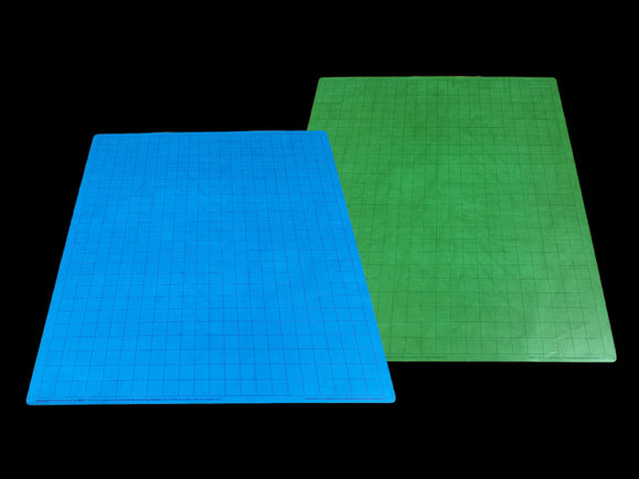 A reversible battle mat designed for gaming, featuring a blue side with a grid pattern and a green side, ideal for various tabletop games and strategies.