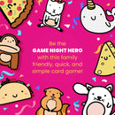 Colorful card game titled 'Taco Cat Goat Cheese Pizza' by Dolphin Hat Games, featuring cute illustrated characters like tacos, cats, and unicorns, set against a vibrant pink background with confetti. The text highlights the game as a family-friendly, quick, and simple card game.