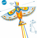 A giant bird-shaped kite by DJECO, featuring vibrant colors and intricate designs. The kite measures 125 cm (49.2 inches) and includes long colorful tails. It is ideal for outdoor fun and encourages creativity and play.