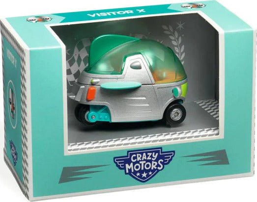 The Crazy Motors: Visitor X toy is a small, colorful vehicle featuring a sleek design with a transparent green dome. The vehicle is displayed inside a vibrant blue and silver box that showcases its fun and playful aesthetic, perfect for imaginative play.