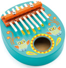 A colorful Animambo musical instrument made by Djeco, featuring a turquoise oval body adorned with playful owl designs and decorative patterns. It has metal keys positioned above a circular sound hole, allowing children to produce melodic sounds as they play.