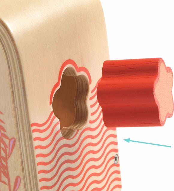 A close-up view of the Multi Boita by DJECO, showcasing its wooden design. The product features a flower-shaped red handle next to a cut-out hole, highlighting its interactive nature. Ideal for engaging young minds, it promotes fine motor skills and creativity.