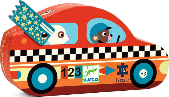 The Racing Car Mini Puzzle by DJECO features a vibrant, cartoon-style racing car with a red and orange color scheme. The puzzle box showcases friendly animal characters: a rabbit and a dog wearing a helmet. The whimsical design includes colorful details such as a checkerboard pattern and star motifs, making it an engaging choice for children aged 3 and up. It consists of 16 pieces, encouraging problem-solving and fine motor skills through play.