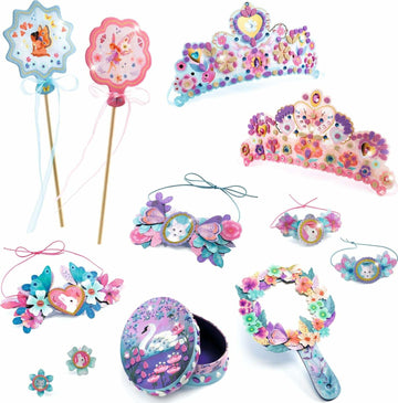 The Nymphea Multi Activity Kit by DJECO includes a variety of colorful and creative crafting items such as decorated crowns, wands, headbands, and a decorative box. Each item is adorned with vibrant flowers, butterflies, and playful designs, perfect for imaginative play and DIY creativity.