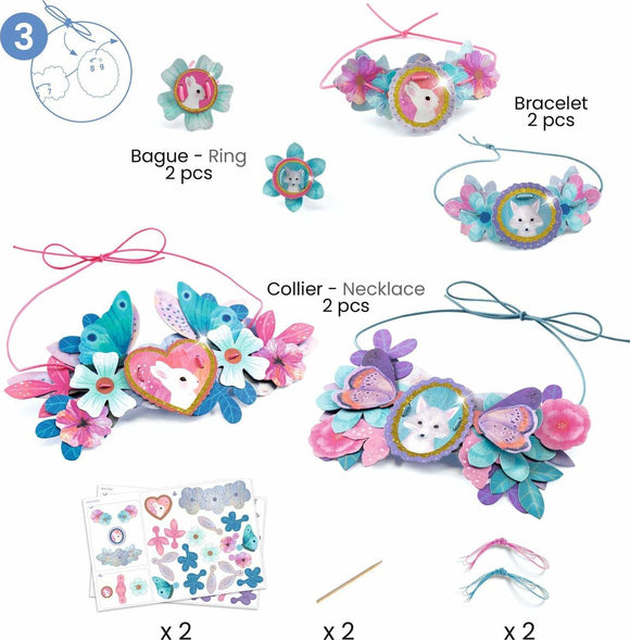 The Nymphea Multi Activity Kit by DJECO features colorful crafting materials, including a bracelet, necklace, and rings adorned with flowers and butterflies. It showcases creativity and encourages hands-on activities for children, perfect for developing fine motor skills and imaginative play.