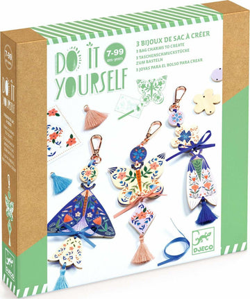 A DIY kit featuring Butterfly Bag Charms by DJECO, displaying three beautifully designed bag charms. Each charm has floral patterns and colorful tassels, perfect for personalizing bags or accessories. The packaging highlights the kit's creative potential with vibrant images and a playful design.