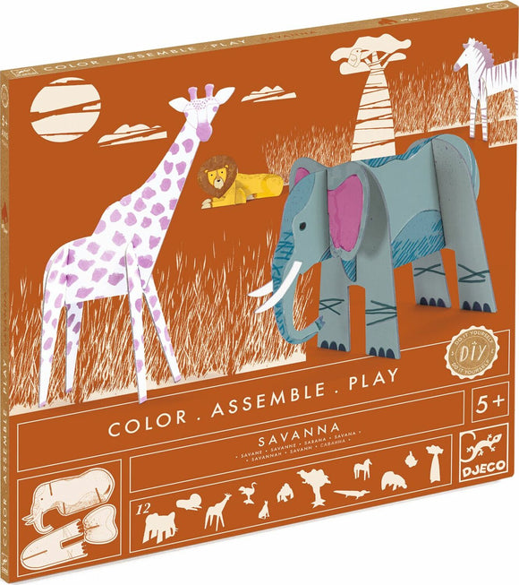 The Savanna Color. Assemble. Play DIY kit by DJECO features vibrant paper cutouts of various savanna animals such as a giraffe, lion, and elephant. The kit encourages children to color, assemble, and play with their own handcrafted animal figures in a creatively illustrated savanna landscape.