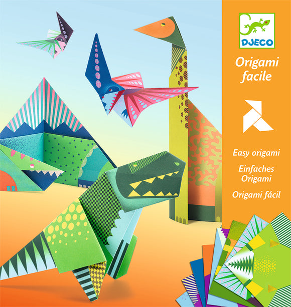 Dinosaur Origami kit by DJECO featuring colorful paper folds of various dinosaurs and flying creatures. The image shows completed origami models, including a T-Rex, a flying pterosaur, and other geometric designs, all made with vibrant, patterned paper. The packaging highlights 'Easy origami' and features illustrations of the finished models.