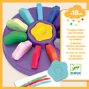A vibrant set of 12 flower-shaped crayons designed for toddlers, displayed in a circular holder. Each crayon features a unique pastel color, perfect for little hands to explore their creativity. Includes a sheet of paper showing colorful crayon strokes.
