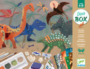 The World of Dinosaurs DIY kit by DJECO featuring colorful dinosaur and nature illustrations. Includes various art supplies like paints, brushes, and decorative elements for creative activities. Suitable for children aged 6 to 10.