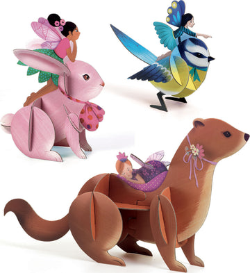 The Fairy Box Multi-Activity Kit by DJECO features whimsical wooden figures including a pink rabbit with a fairy, a vibrant bird with a fairy, and a brown otter carrying a fairy. Each character is beautifully designed, ideal for imaginative play and creative DIY activities.