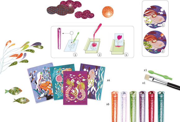 DJECO Mermaid Lights Glitter Boards DIY kit featuring four colorful boards, six glitter tubes in various colors, a brush, and a stylus. The packaging shows step-by-step instructions for creating shimmering art with mermaid and underwater themes.