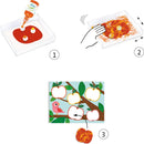Creative DIY kit from DJECO, featuring Nature Painting Marble Painting. The kit includes colorful paint, a tray for mixing, and cards to create artistic apple designs with marbling effects, aimed at children's imaginative play.