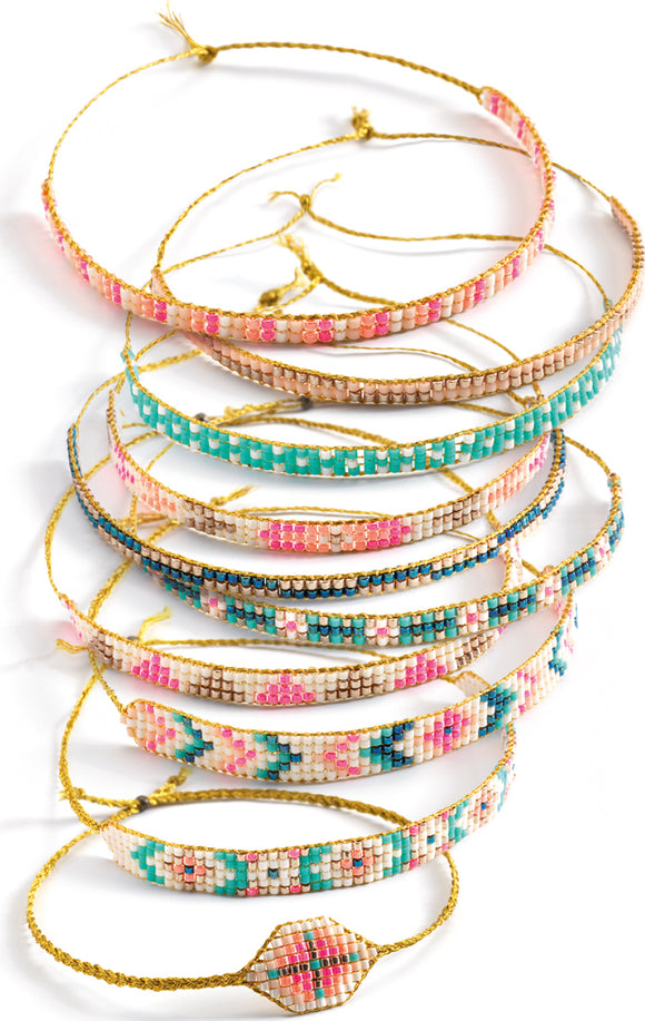 A collection of brightly colored DIY bracelets made from tiny beads, featuring intricate patterns and braided gold strings. The bracelets are displayed in a stacked arrangement, showcasing various colors including pinks, blues, and gold accents, ideal for creative play and crafting.