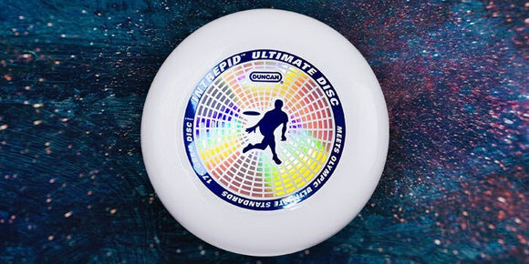 The Intrepid Ultimate Disc by Duncan is a 175g flying disc designed for ultimate frisbee. The disc features vibrant colors and a dynamic pattern centered around an image of a player in action, showcasing its durability and performance for outdoor gaming.