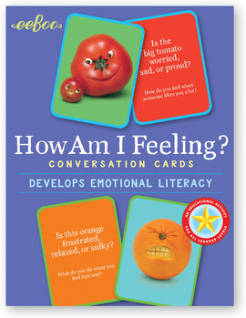 Colorful package of 'How Am I Feeling?' conversation cards by Eeboo, featuring cartoonish tomatoes and oranges expressing various emotions. The cards are designed to develop emotional literacy, showcasing questions about feelings like frustration, pride, and sadness.