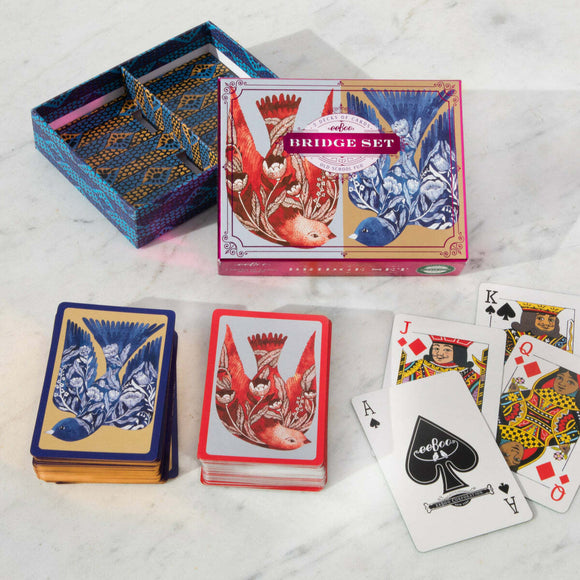 Bridge Playing Cards set featuring vibrant artwork of birds on the card backs and the beautifully designed box. Includes a blend of red and blue suits, showcasing intricate patterns and colors that enhance your gaming experience. Perfect for both casual and serious players.