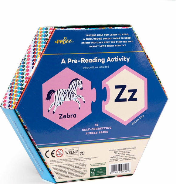 The Alphabet Puzzle Pairs by Eeboo features a colorful hexagonal box displaying a zebra illustration paired with the letter 'Z'. The box emphasizes fun and educational pre-reading activities, promoting letter and picture matching with 33 self-correcting puzzle pairs. Instructions are included for easy play.