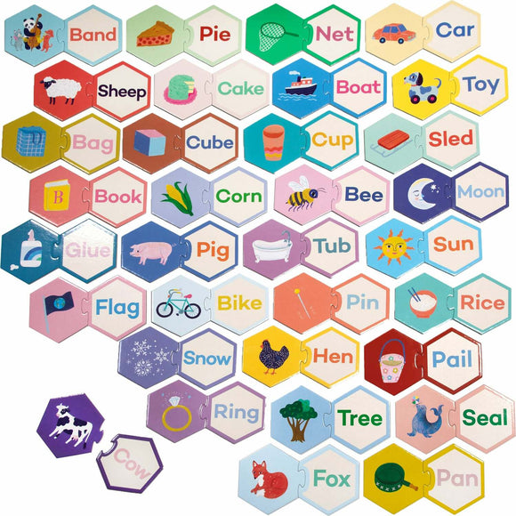 A colorful jigsaw puzzle featuring hexagonal pieces with illustrations of various objects and animals alongside their corresponding words. Pieces include drawings of a cow, a pig, a bicycle, and everyday items like a book, cup, and cake, designed to help with word recognition and cognitive skills for children.