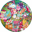 A vibrant 500-piece jigsaw puzzle by Eeboo, featuring an artistic charcuterie board design filled with colorful fruits, vegetables, cheeses, and meats, set against a lush green background. The circular layout showcases a variety of delicacies that create an inviting and festive atmosphere, perfect for puzzle enthusiasts and food lovers alike.