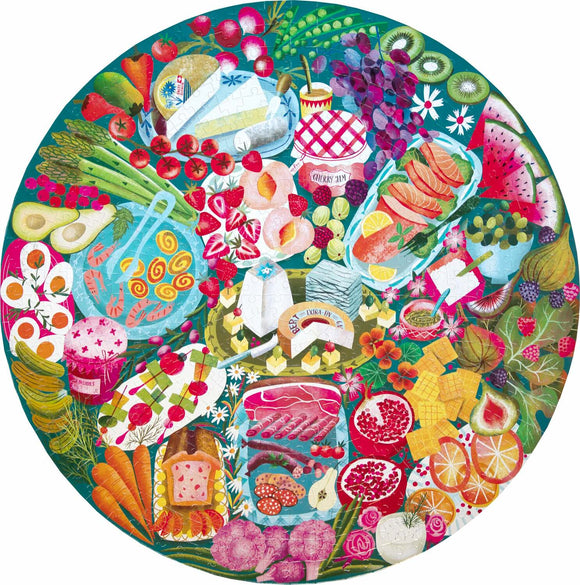 A vibrant 500-piece jigsaw puzzle by Eeboo, featuring an artistic charcuterie board design filled with colorful fruits, vegetables, cheeses, and meats, set against a lush green background. The circular layout showcases a variety of delicacies that create an inviting and festive atmosphere, perfect for puzzle enthusiasts and food lovers alike.