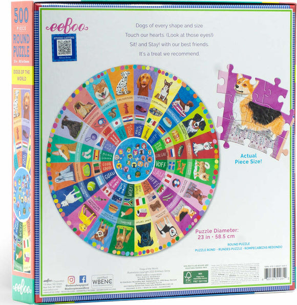 An enchanting 500-piece round jigsaw puzzle titled 'Dogs of the World' by Eeboo. The design features a colorful collage of dog breeds from around the globe, with a vibrant border and an image of a puzzle piece showing a Corgi. The box displays playful dog illustrations and the puzzle's dimensions, 23 inches in diameter.