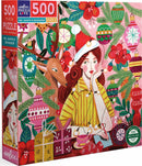 A beautifully illustrated jigsaw puzzle box featuring Ms. Santa with long red hair, a reindeer, and festive decorations. The scene includes colorful ornaments, flowers, and presents, conveying a cheerful holiday spirit. The puzzle consists of 500 pieces and is made by Eeboo, emphasizing eco-friendly materials.