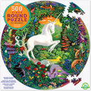 A colorful 500-piece round jigsaw puzzle titled 'Unicorn Garden' by Eeboo. The design features a majestic white unicorn amidst a lush landscape filled with vibrant flowers, butterflies, and various animals in a magical garden setting.