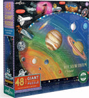 Eeboo Solar System & Beyond jigsaw puzzle featuring a colorful illustration of planets and space exploration. The puzzle includes 48 giant pieces and comes with an informational poster. It is designed for ages 4 and up, showcasing historical satellites and the planets in our solar system.