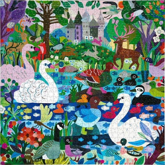 A colorful jigsaw puzzle titled 'Ducks in the Clearing' by Eeboo, featuring various ducks and swans in a vibrant natural setting with a castle in the background. The scene includes lush greenery, flowers, and other wildlife, creating a picturesque landscape full of intricate details and bright colors.
