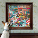 A framed jigsaw puzzle depicting a vibrant English market scene filled with colorful flowers, fruits, and baked goods. A small dog curiously gazes at the artwork, enhancing the cozy atmosphere of a home decorated with floral wallpaper.