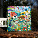 Eeboo's English Hedgerow jigsaw puzzle featuring a vibrant and colorful rural scene filled with animals, flowers, and farm elements. The box displays a detailed illustration of nature with a variety of wildlife, including cows, birds, and gardens, perfect for puzzle enthusiasts. Contains 1000 pieces, made from recycled materials.