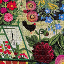 A colorful Garden Harvest jigsaw puzzle featuring vibrant flowers, a black chicken, and gardening tools, showcasing a lush garden scene. The puzzle has 1000 pieces and is a delightful activity for nature lovers and puzzle enthusiasts.