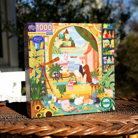 The box for the Eeboo jigsaw puzzle titled 'Reading & Relaxing.' The artwork features a cozy reading scene with a woman reading indoors, surrounded by plants, books, and a telescope. The vibrant illustration is framed by elements such as sunflowers and various colorful items scattered around, inviting a sense of tranquility and leisure.