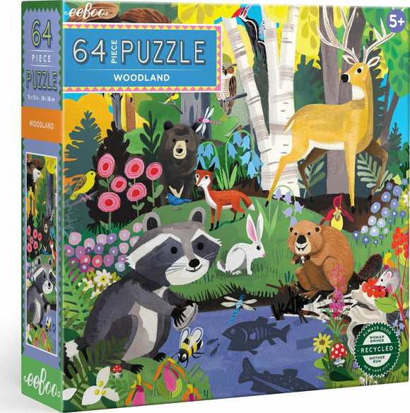 The packaging of the Eeboo Woodland jigsaw puzzle featuring 64 colorful pieces. The design showcases adorable woodland animals, including a raccoon, deer, bear, fox, and various birds, surrounded by vivid flowers and trees. The puzzle is suitable for ages 5 and up, with its dimensions listed as 15 x 15 inches (38 x 38 cm). The box emphasizes its eco-friendly materials and woman-owned production.