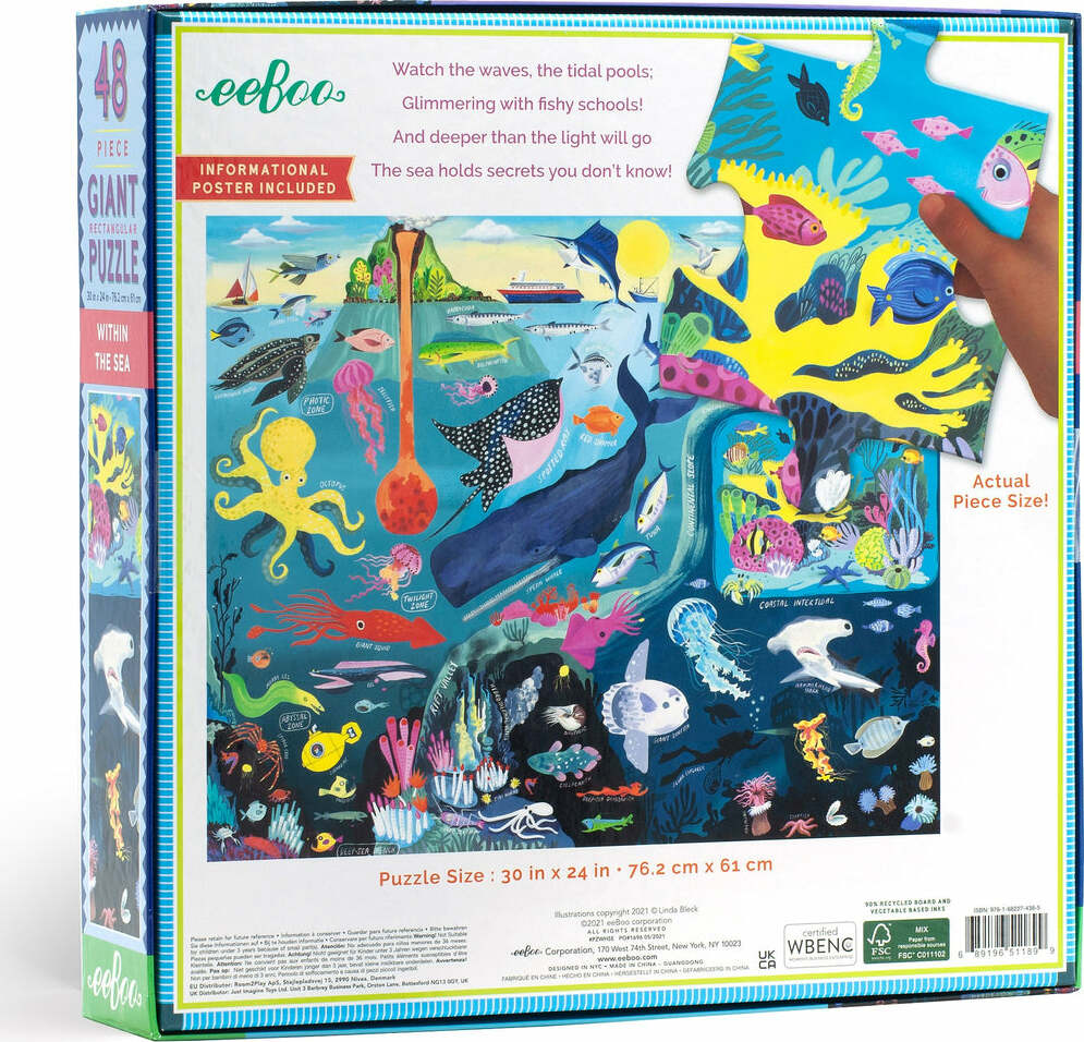 Eeboo Within the Sea 48-piece giant jigsaw puzzle featuring a vibrant underwater scene with colorful marine life including fish, octopus, and corals. A hand holds a puzzle piece alongside an informational poster included with the product. The puzzle size is 30 x 24 inches.