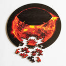 Jigsaw showing partial eclipse with sun-shaped whimsey piece and other pieces