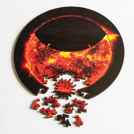 Jigsaw showing partial eclipse with sun-shaped whimsey piece and other pieces