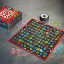 Robot Face Race game by Educational Insights displayed on a steel table. The vibrant game board features colorful robot faces in various designs arranged in a grid. Nearby are game pieces in different shapes and colors, along with the game box.
