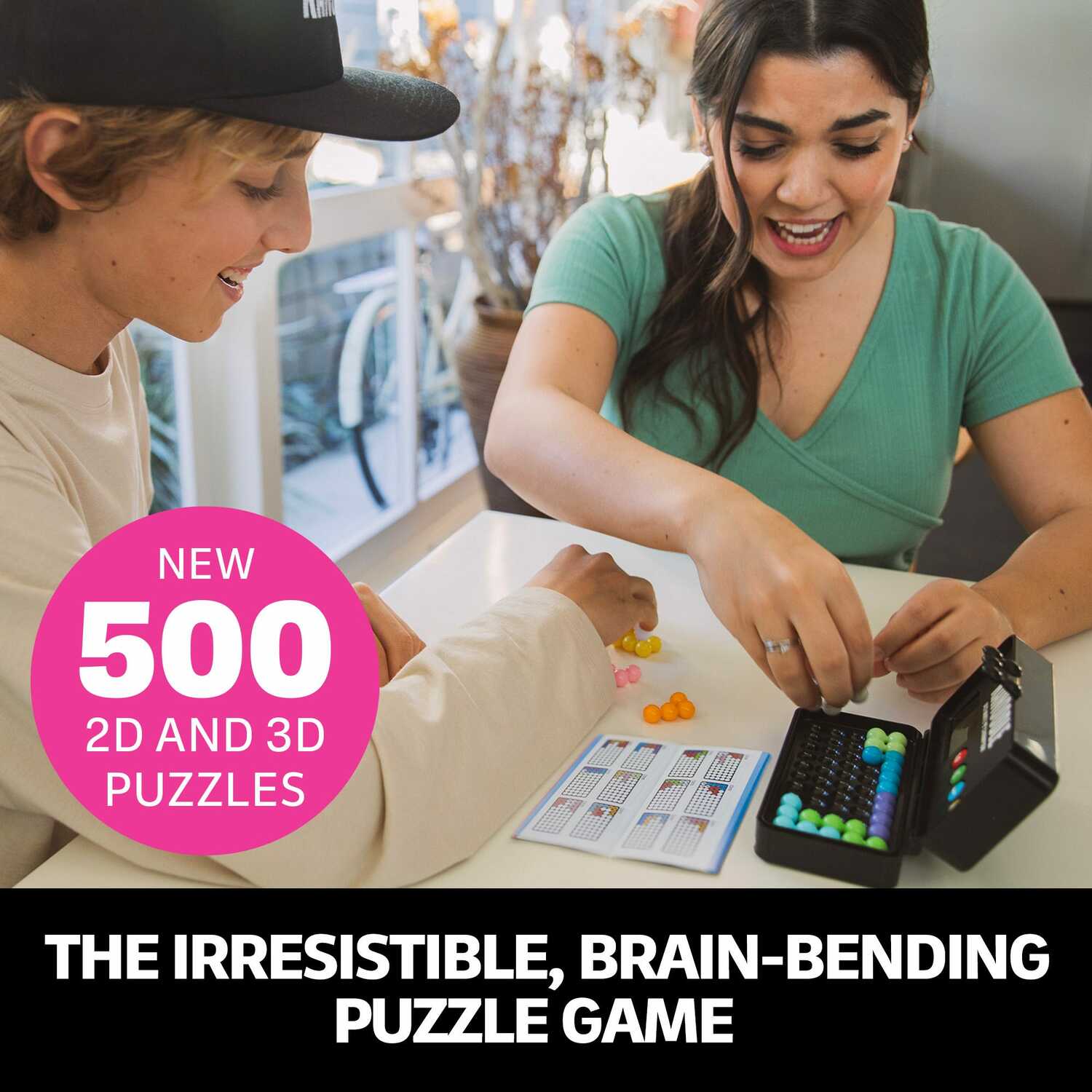 Two people playing the Kanoodle Ultimate Champion puzzle game on a table. One person is arranging colorful pieces while the other is looking at a game card. The product features both 2D and 3D puzzle challenges, making it an engaging brain-teaser suitable for all ages.