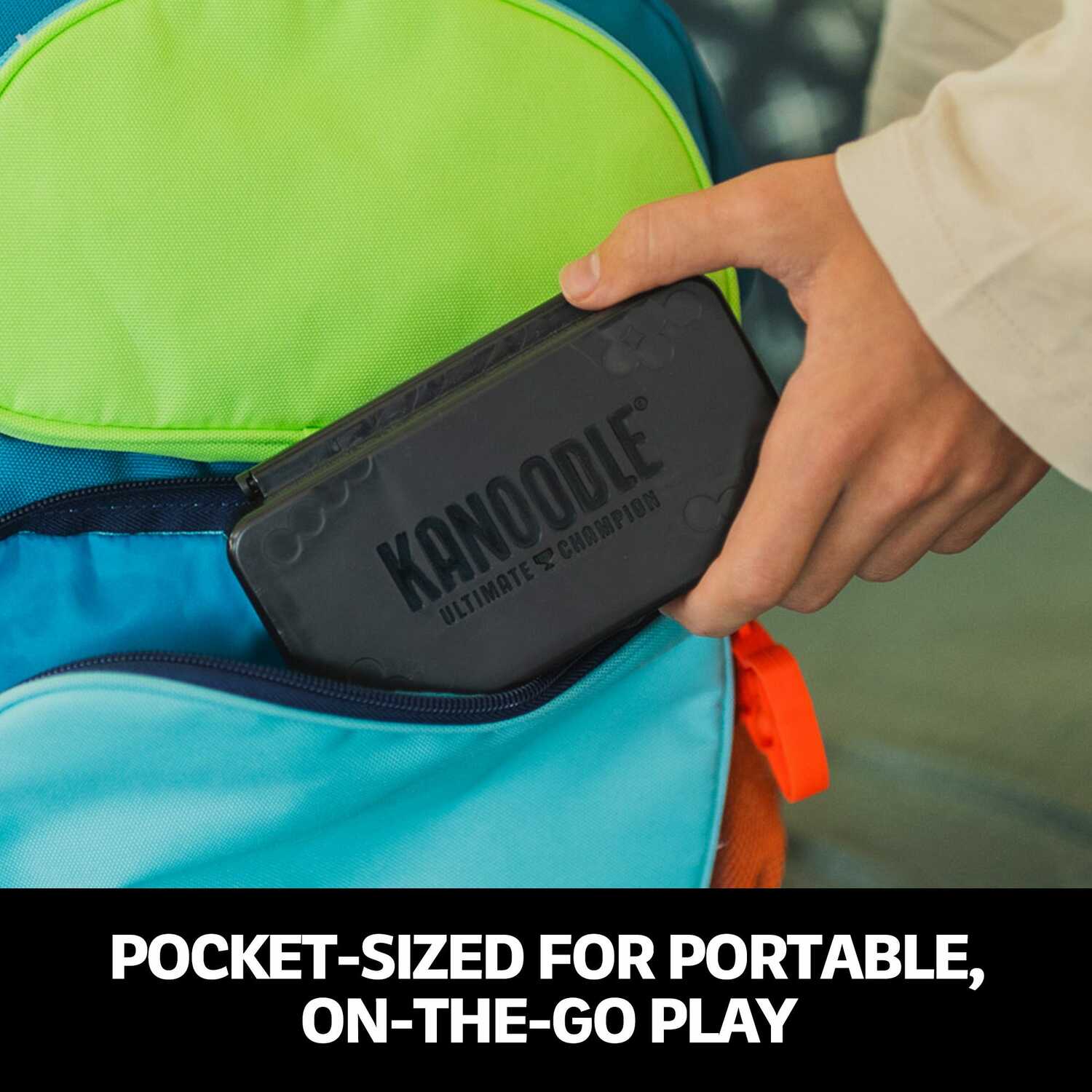 A person is placing the Kanoodle Ultimate Champion mechanical puzzle into a pocket of a colorful backpack. The puzzle is compact and designed for easy portability, making it perfect for on-the-go play. The backpack features vibrant colors.