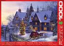 A cozy winter scene depicted in a jigsaw puzzle titled 'Home for the Holidays' by Dominic Davison. The image features a snowy landscape with two charming, decorated houses, a brightly lit Christmas tree, and a horse-drawn carriage parked near a gated entrance. The atmosphere is warm and inviting, perfect for holiday gatherings.