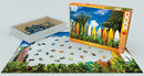 Surfer's Paradise Hawaii jigsaw puzzle by Eurographics, featuring a vibrant image of colorful surfboards against a lush tropical backdrop. The puzzle box stands next to its partially completed image, showcasing scattered pieces in a white tray. Perfect for puzzle enthusiasts and beach lovers alike.