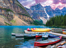 A picturesque scene depicting colorful canoes lined up along a serene lake, surrounded by majestic mountains and lush pine trees. The water reflects the vibrant colors of the canoes and the dramatic sky overhead, creating a tranquil nature setting perfect for puzzle enthusiasts.