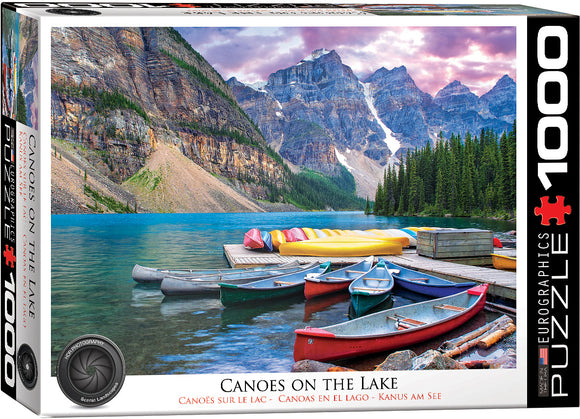 A colorful jigsaw puzzle box featuring a serene image of canoes docked by a pristine lake surrounded by majestic mountains and lush forests under a beautiful sky.