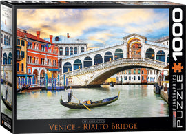 Eurographics jigsaw puzzle featuring the iconic Rialto Bridge in Venice. The scene depicts charming historic buildings, a gondola on the canal, and a vibrant sky, providing a colorful and engaging puzzle experience for enthusiasts.